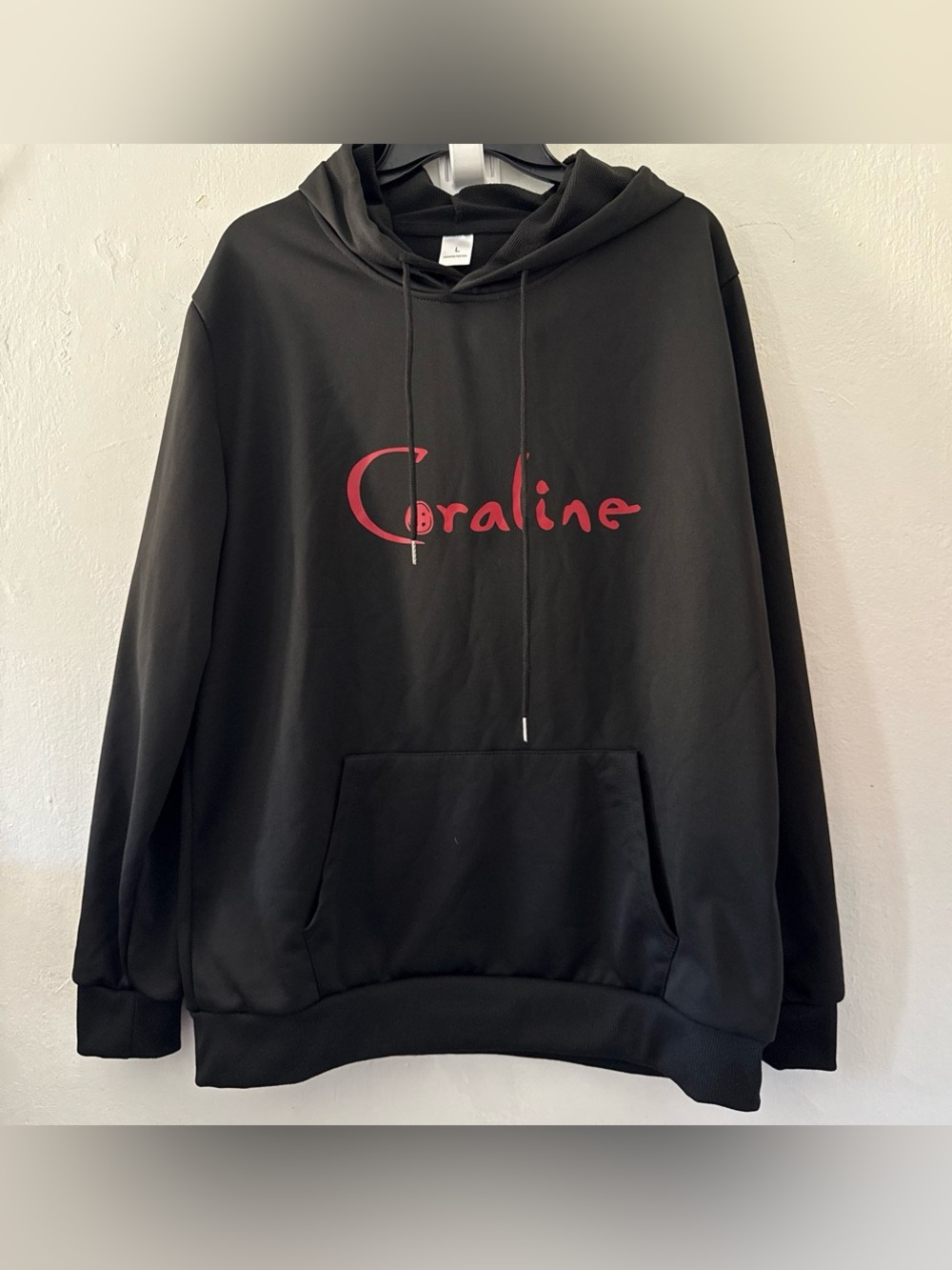 Black Coraline hoodie with red 'Coraline' text #coraline #movie